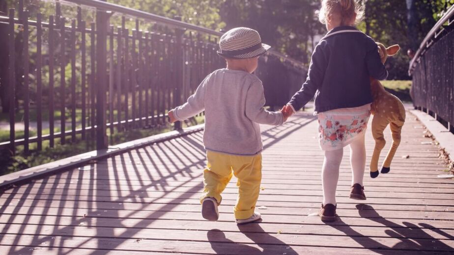 A parent and child walking together