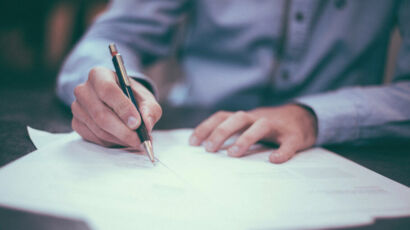 A person writing at a desk