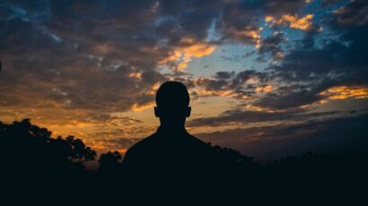A person looking out at sunset
