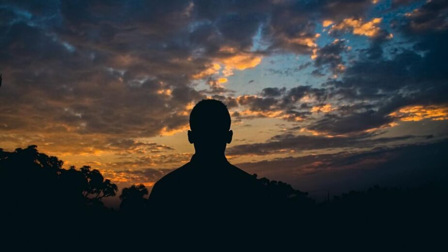 A person looking out at sunset
